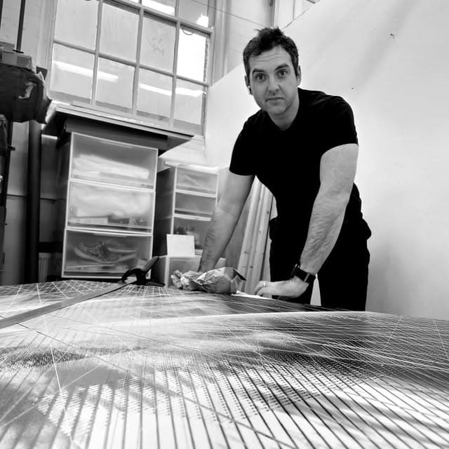 Charles Harrop-Griffiths working on an engraved panel in his studio